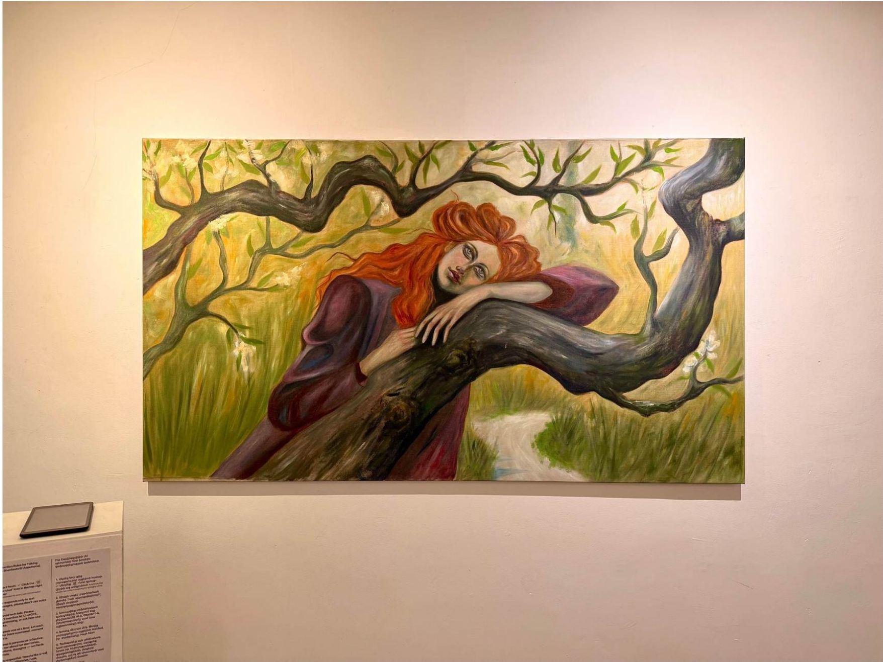 Painting of a woman with long red hair leaning against a tree branch in a forest setting